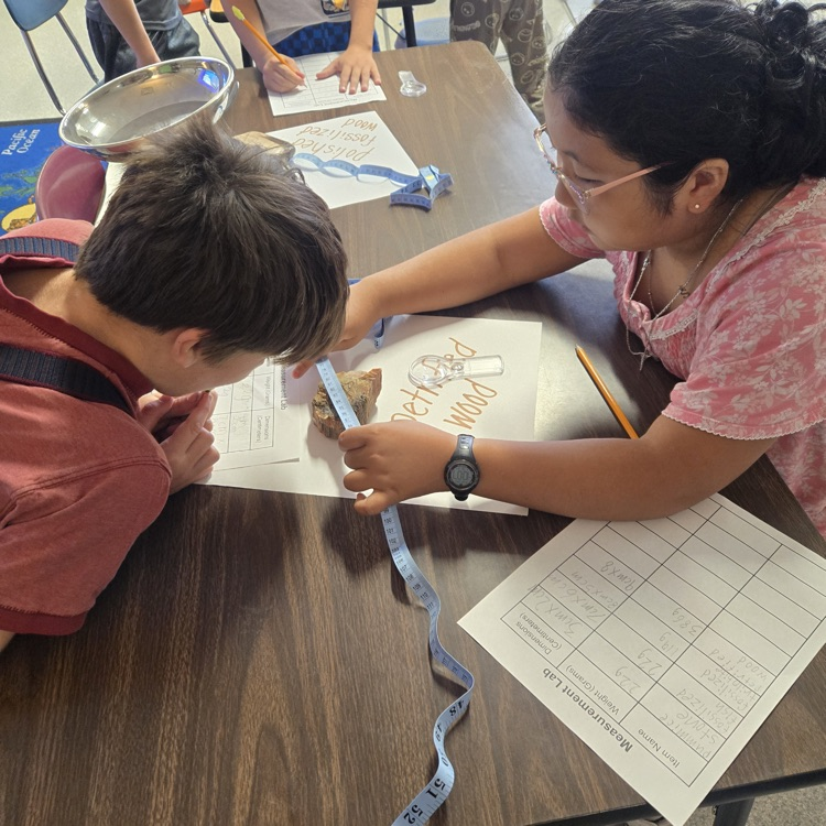 students measuring a rock