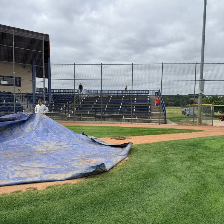 students covering pitchers mound on merchants field