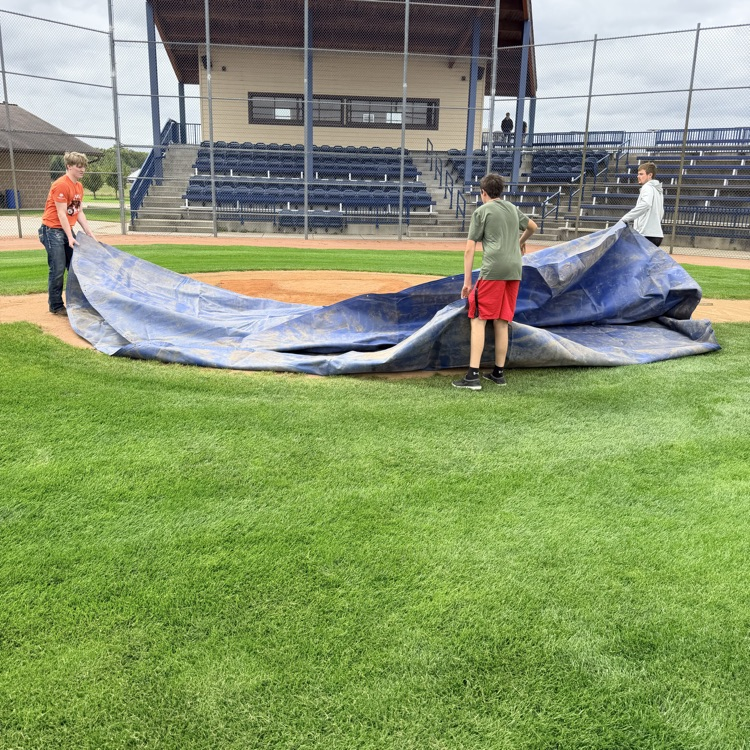 students covering mound at merchants field
