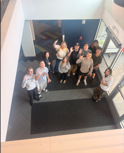 students looking up and waving