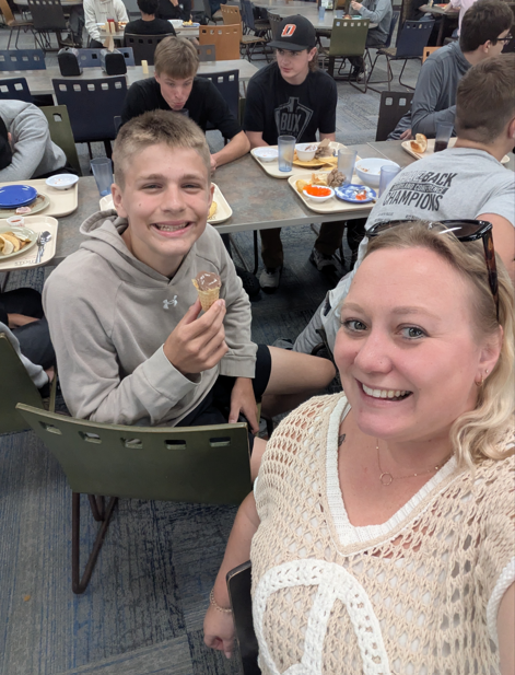 student and teacher in lunchroom