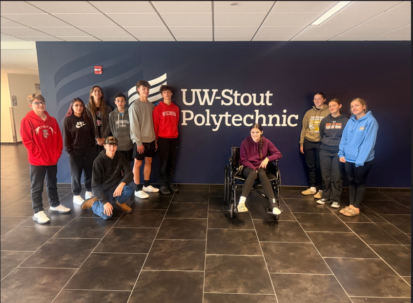students posing in front of sign that says UW-Stout Polytechnic