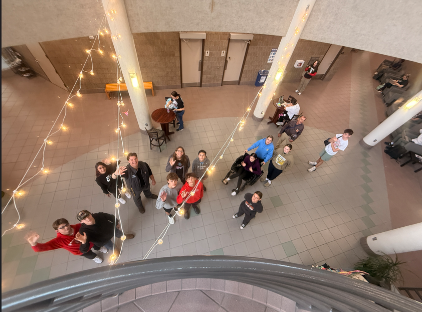 students looking up and waving
