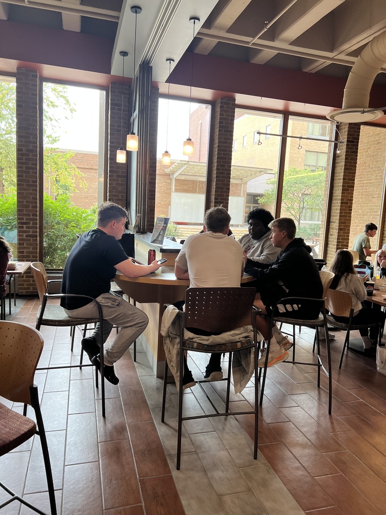 Four students eating lunch at a table