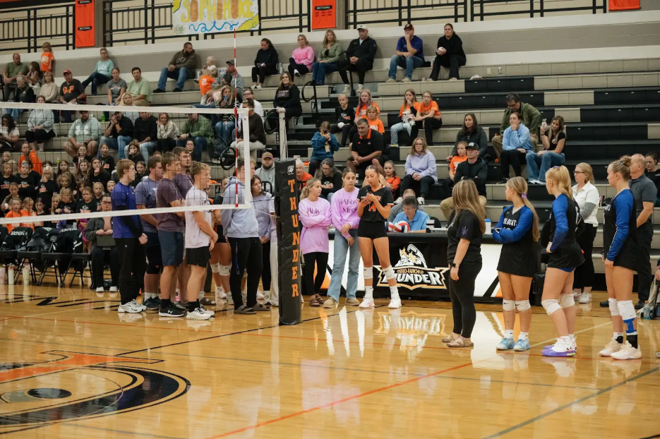 Volleyball players speaking courtside