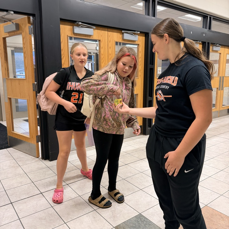students being greeted as they enter school 