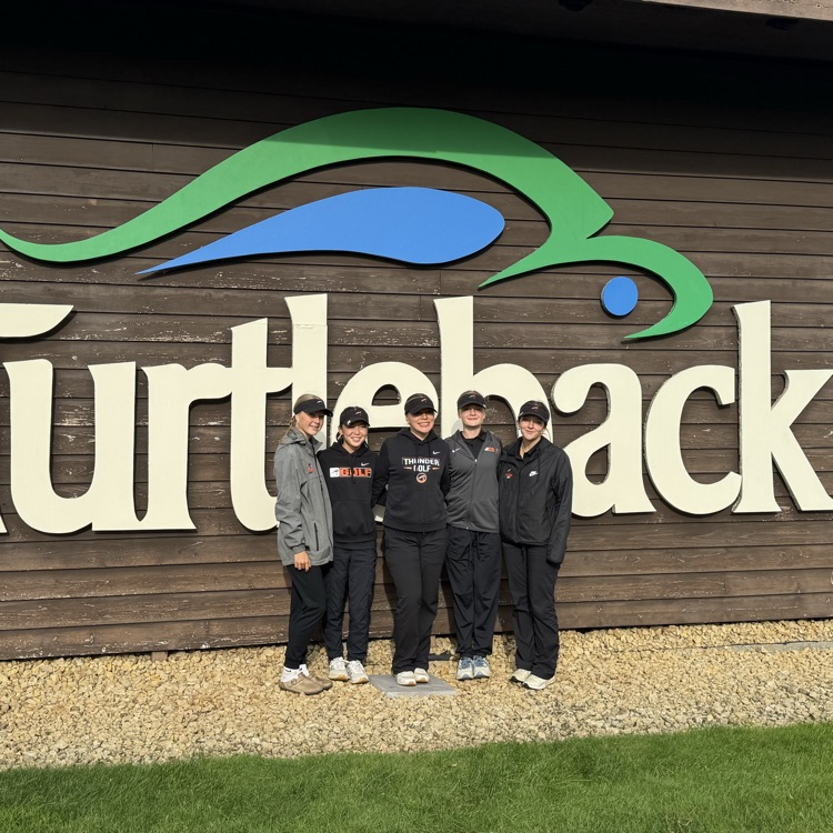 girls golf team in front of turtle back sign 