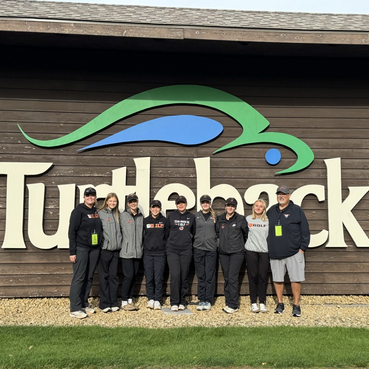 girls golf team in front of turtle back sign 
