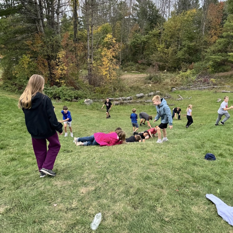 students rolling down hill