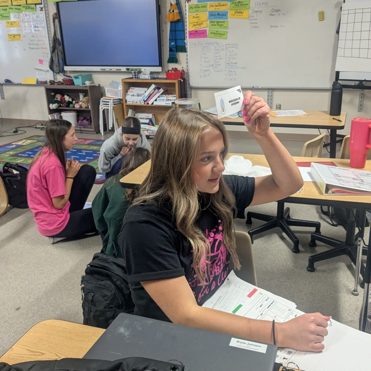 girl holding card above head