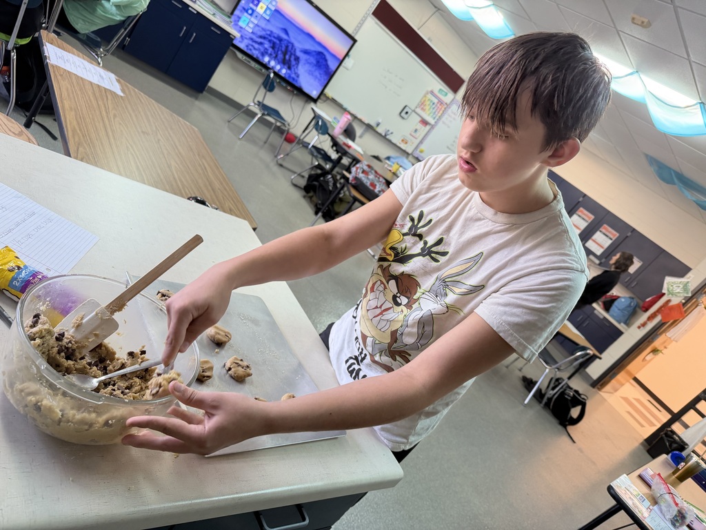 student scooping cookies