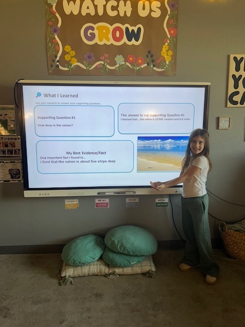 Student presenting near SmartBoard