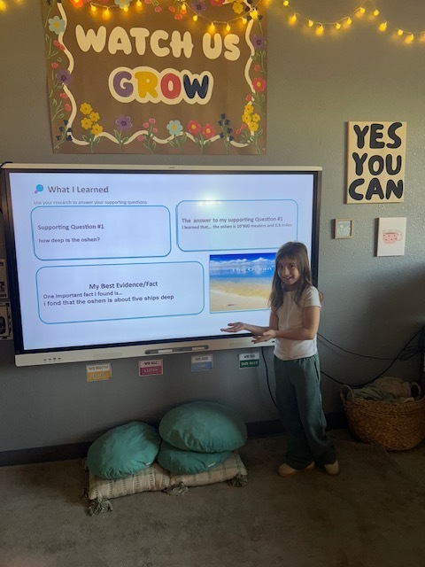 Student presenting near SmartBoard
