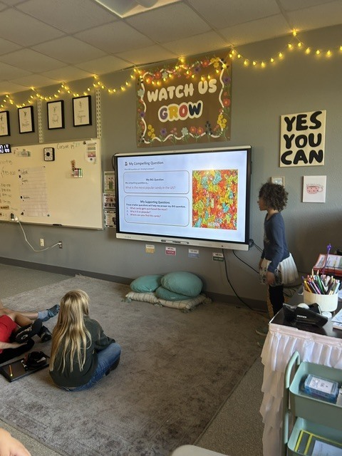 Student presenting near SmartBoard