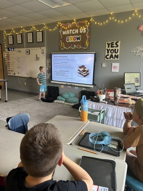 Student presenting near SmartBoard