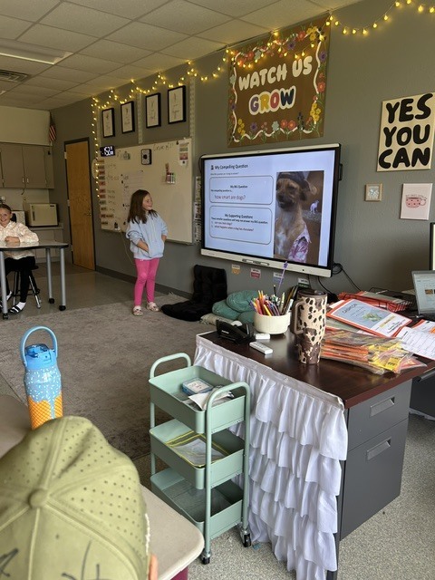 Student presenting near SmartBoard