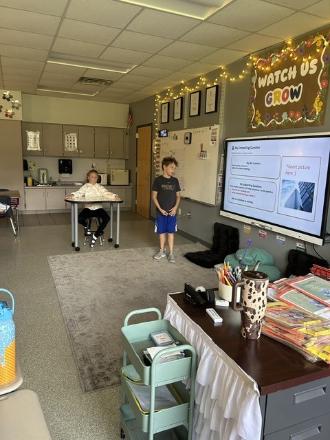Student presenting near SmartBoard