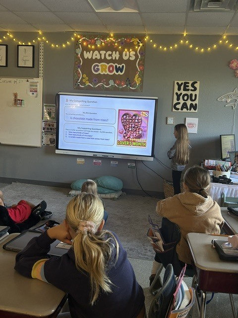 Student presenting near SmartBoard