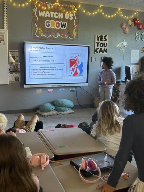 Student presenting near SmartBoard