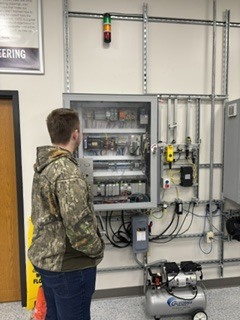 Student looking at wall of electical