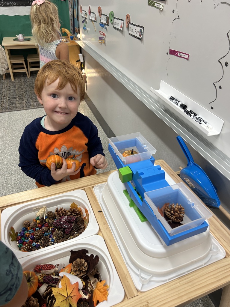 Image Description for accessibility: Boy at sensory table