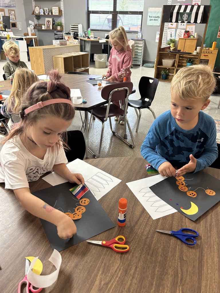 Image Description for accessibility: Students working on pumpkin art