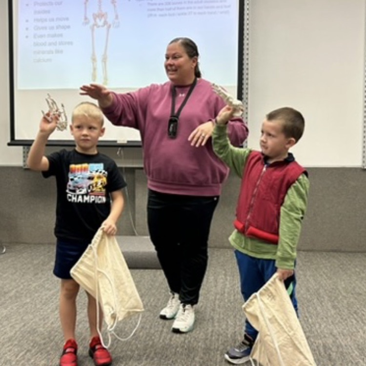 Image Description for accessibility: teacher and students