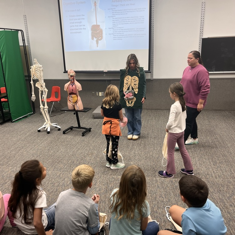 image Description for Accessibility: teacher and students presenting