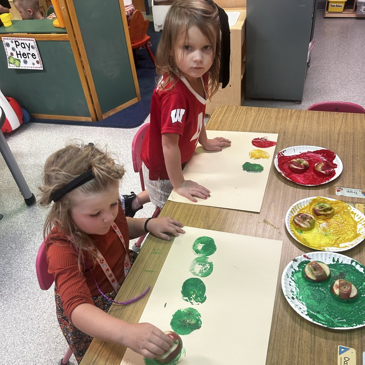 Image description for accessibility. students painting with apples