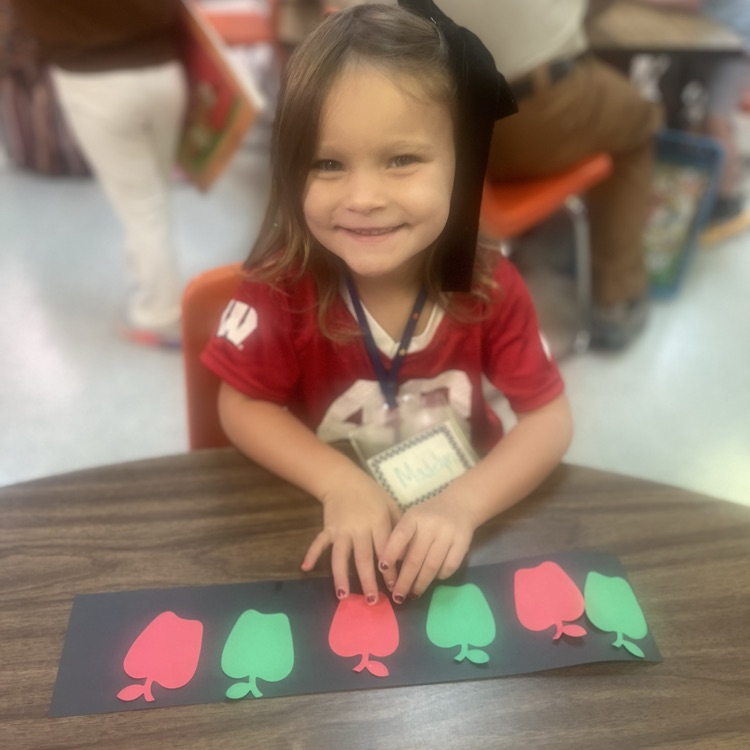 image description for accessibility: student with apple cutouts