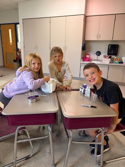 Image Description for accessibility:  Students making a snack in classroom