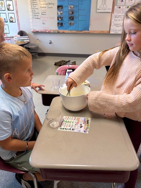 Image Description for accessibility:  Students making a snack in classroom