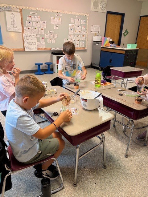 Image Description for accessibility:  Students making a snack in classroom