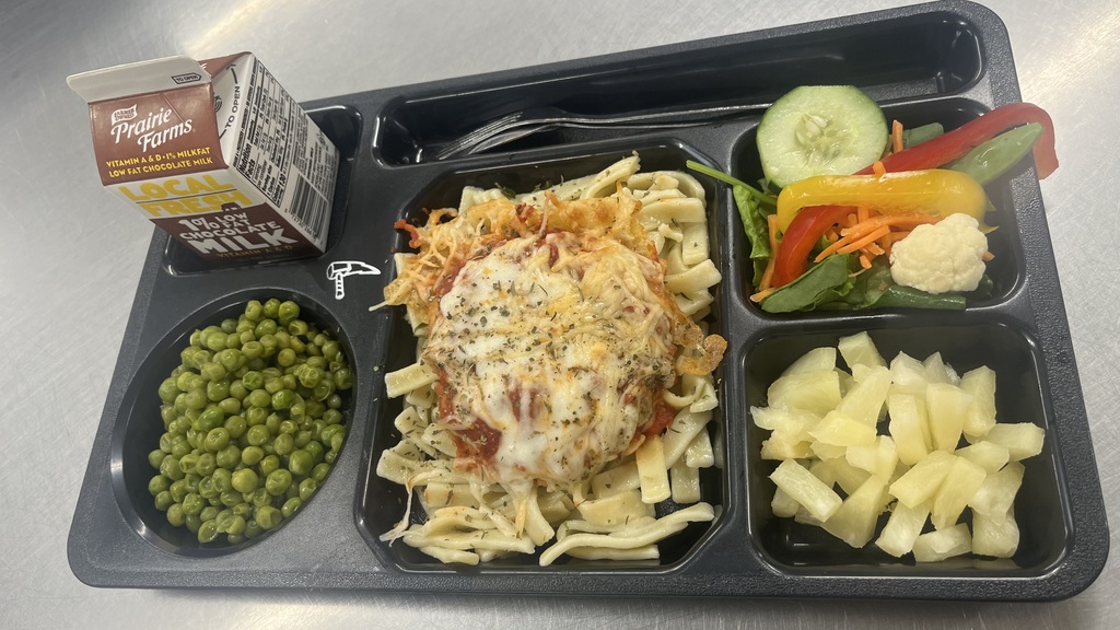 Text Description for accessibility:  School lunch including choc milk, green peas chicken and sauce over noodles, salad and pears