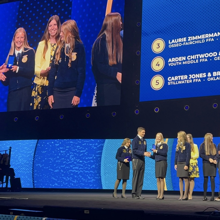image description for accessibility: students on stage receiving award