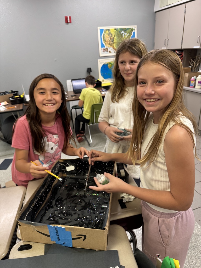 Image Description for accessibility:  Students working on Space Unit projects