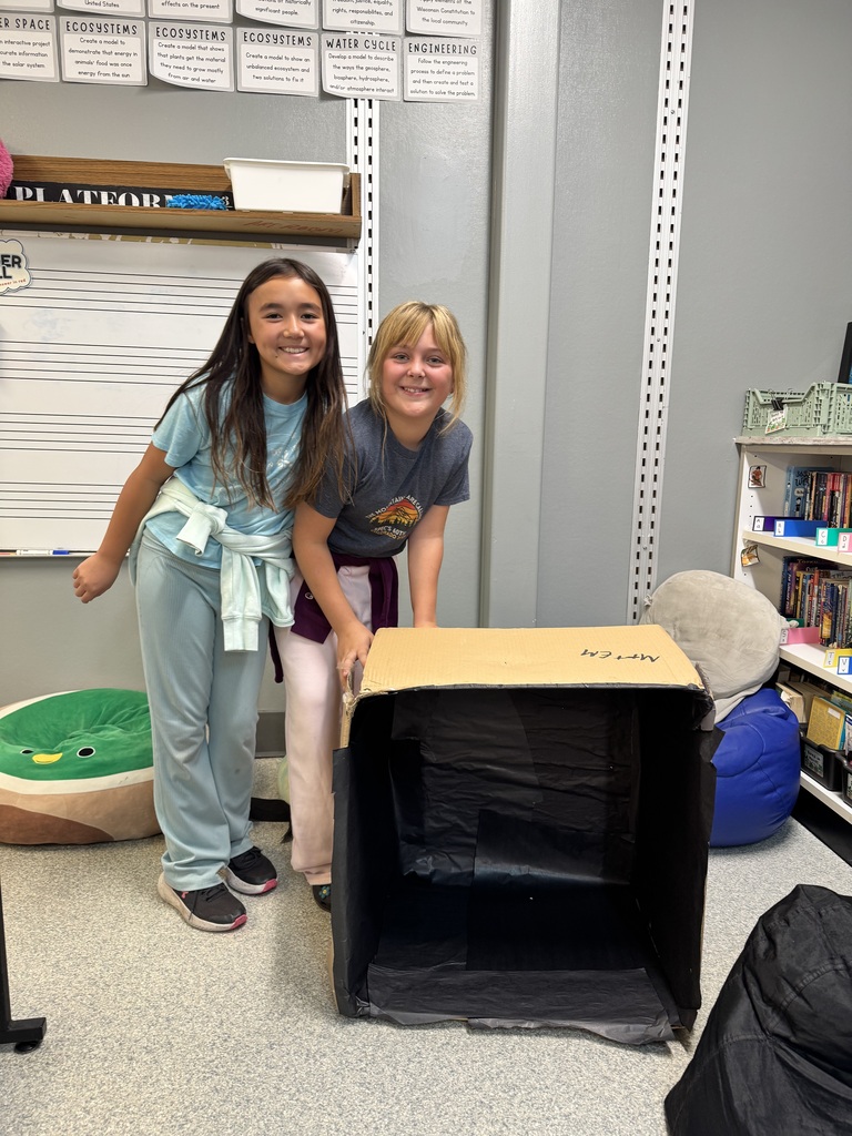 Image Description for accessibility:  Students working on Space Unit projects