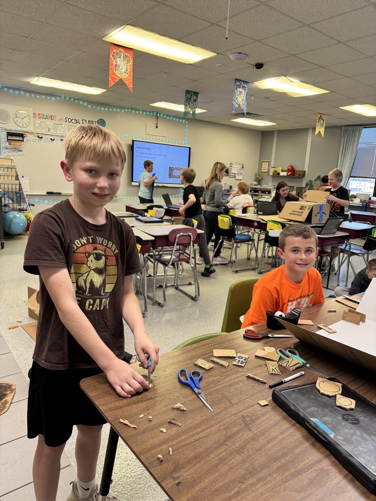 Image Description for accessibility:  Students working on Space Unit projects