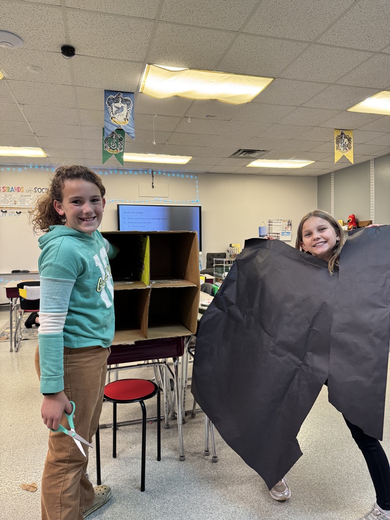 Image Description for accessibility:  Students working on Space Unit projects