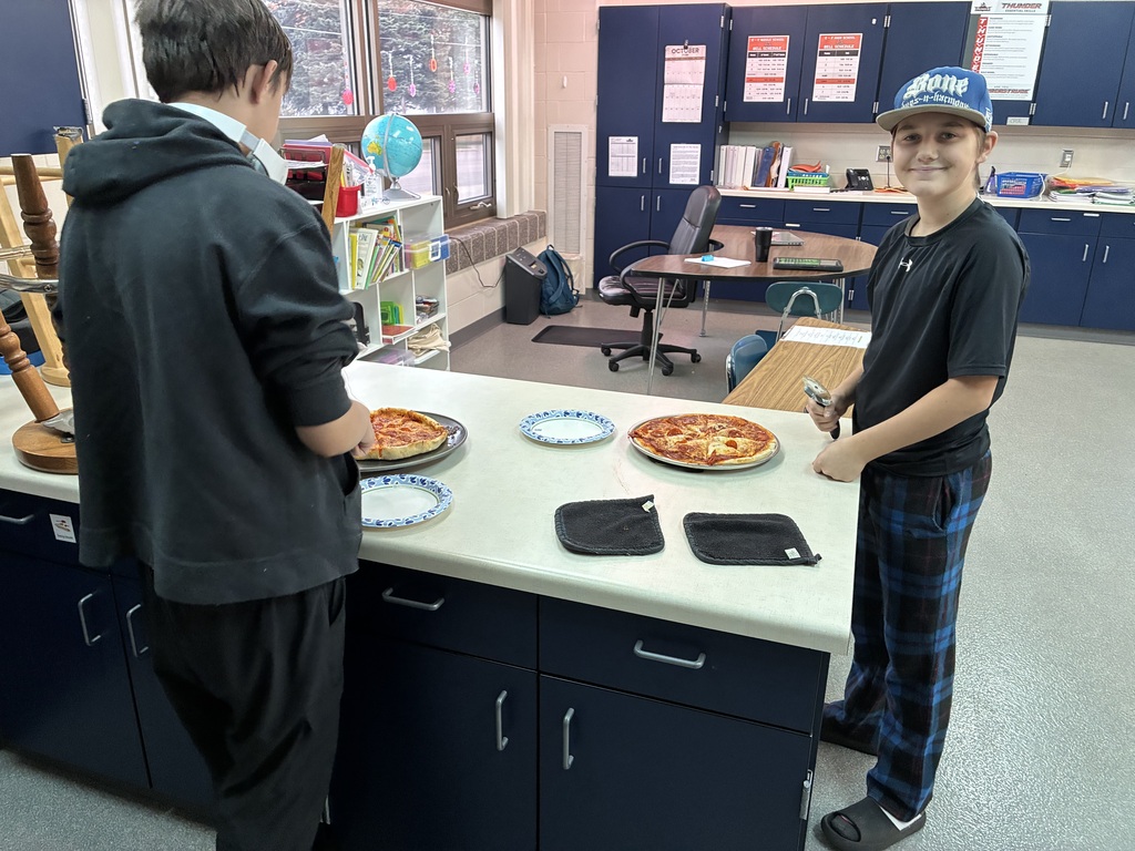 Image Description for accessibility:  Students making pizza
