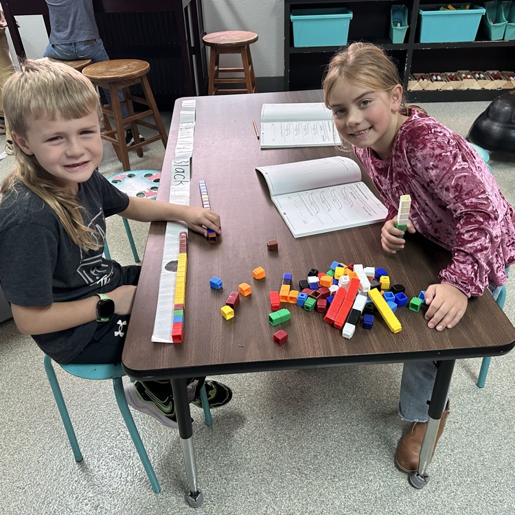 Students measuring with cubes