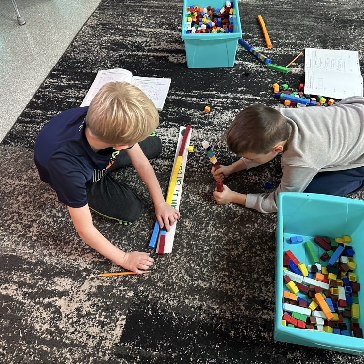 Students measuring with cubes
