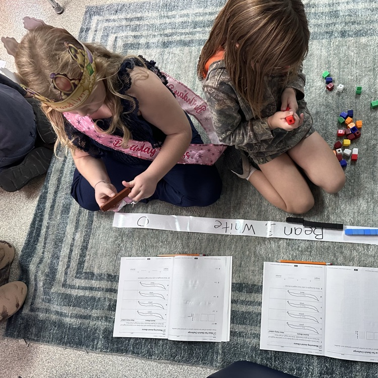 Students measuring with cubes