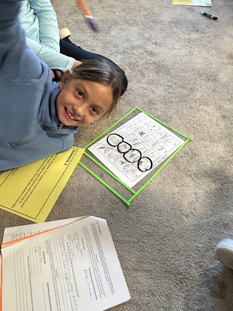 Image description for accessibility:  smiling student laying on classroom rug