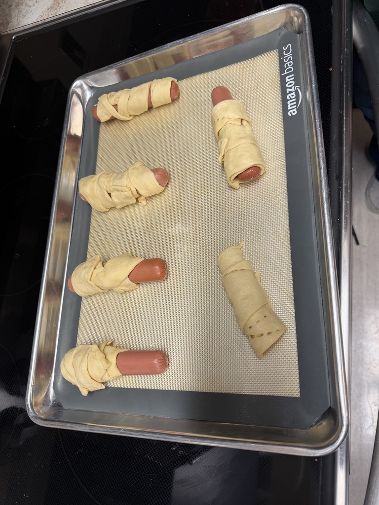 Image Description for accessibility: hot dogs wrapped in dough