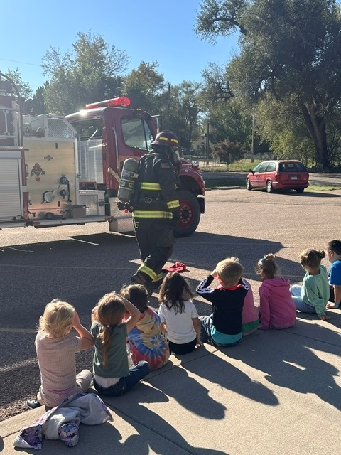 Firefighter in front of CDS children