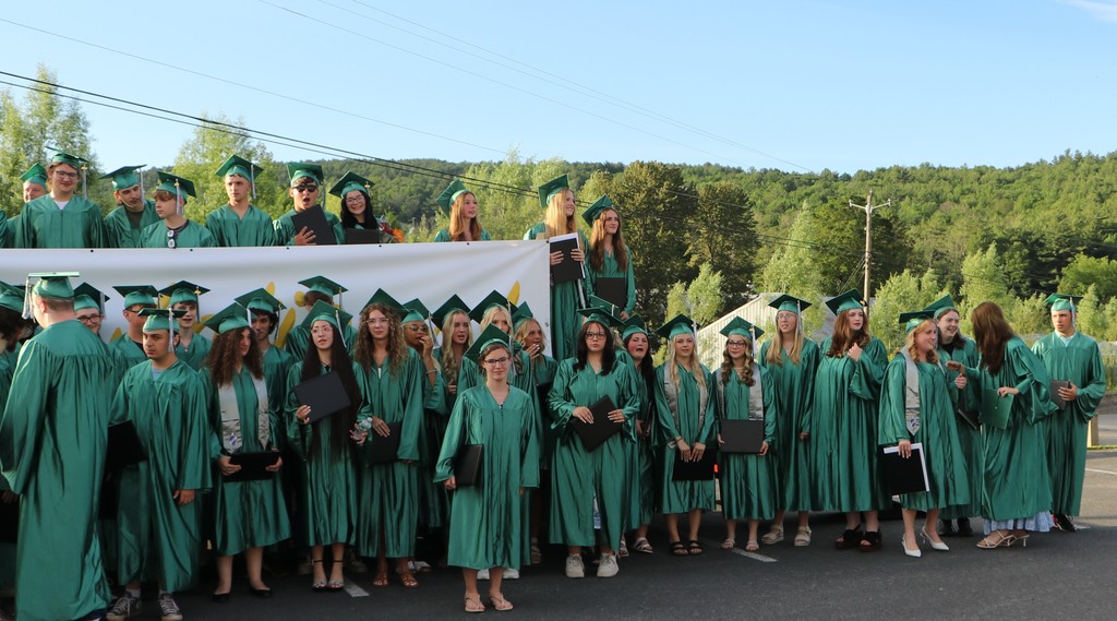 large group of students gathered outside after receiving their certificates
