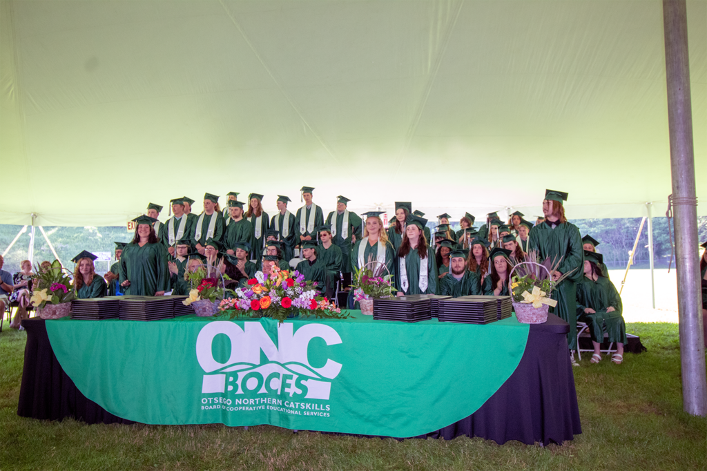 Large group of students standing during the ceremony