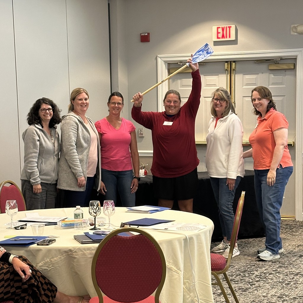 group of 6 people with one holding a paddle-winners of a game