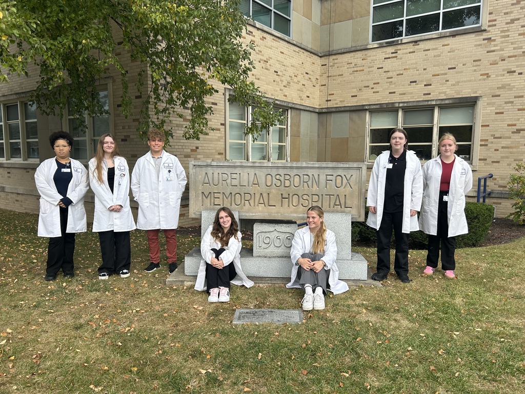 7 students with the AO Fox Memorial Hospital sign
